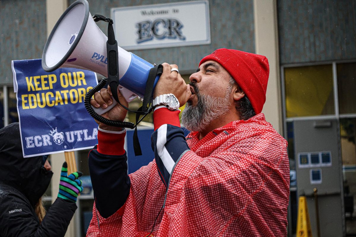 With the rain pouring down, educators strike outside the school to get their demands met 